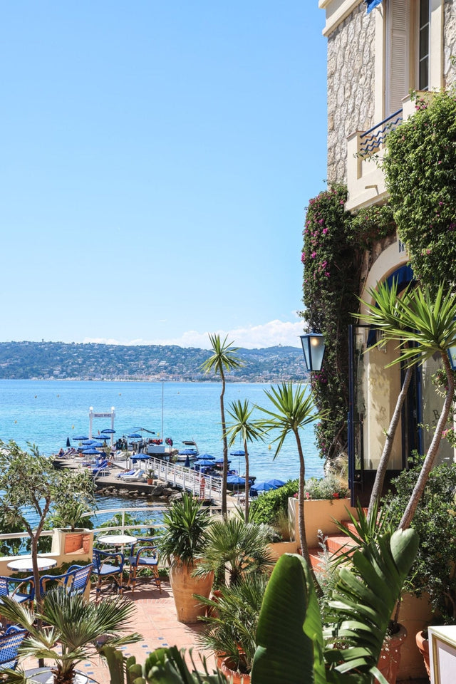 Scenic view of the waterfront with plants at Belles Rives, showcasing Riviera glamour and elegance.