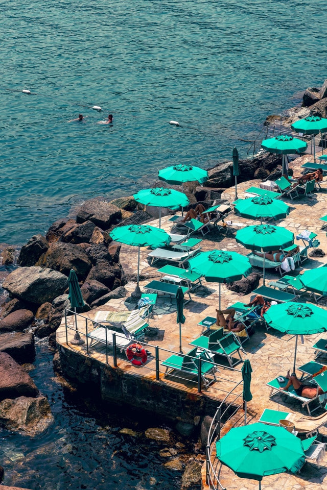 Beach Print of Santa Margherita Ligure featuring green umbrellas by the shoreline.