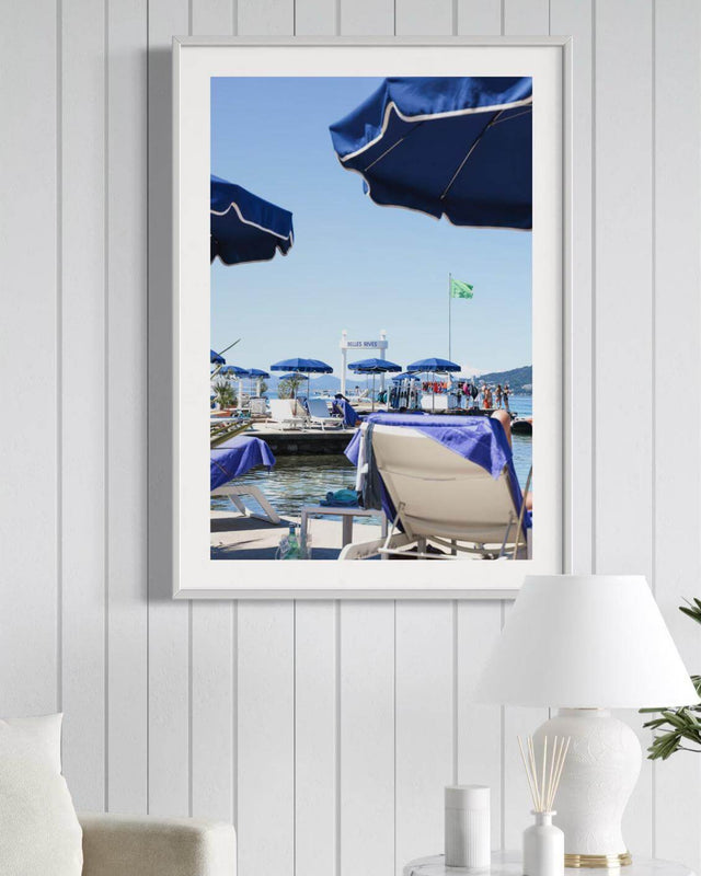 Antibes Print featuring blue parasols and loungers at Hôtel Belles Rives, evoking French Riviera luxury.