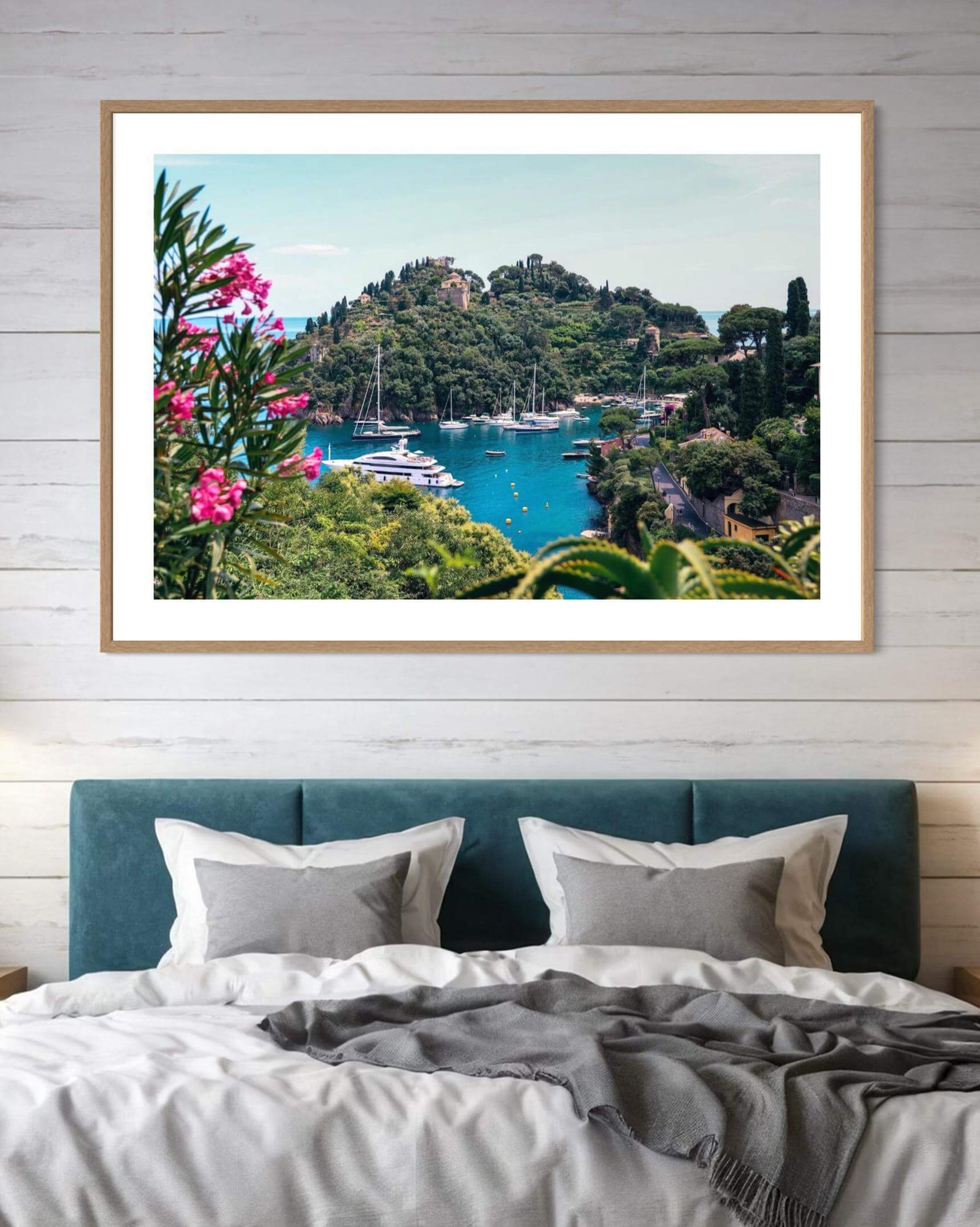 Elegant framed wall Print of Portofino, showcasing boats in the turquoise bay framed by vibrant pink oleander flowers.