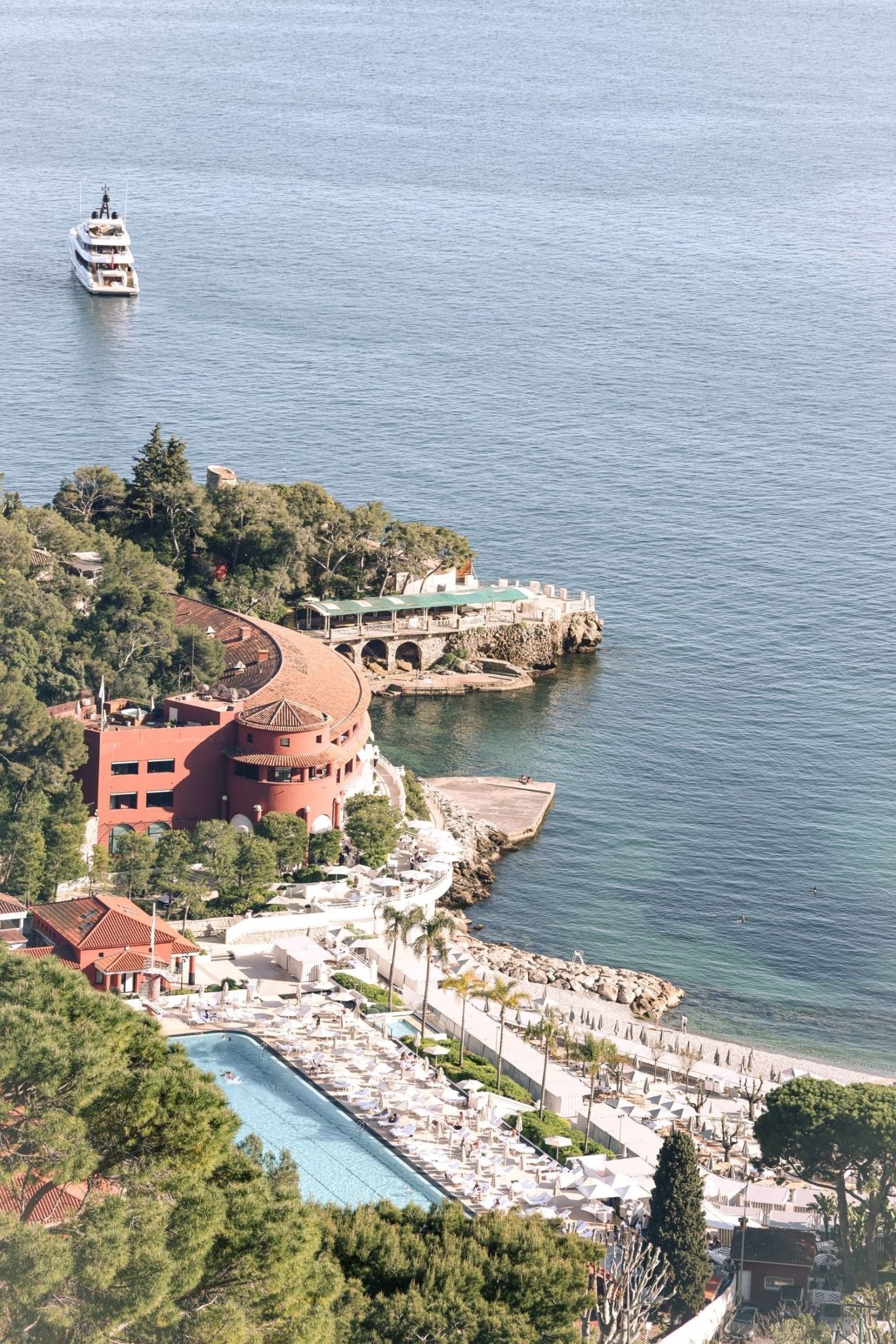 Stunning view of Monte Carlo Beach Club and Mediterranean coast with yacht, showcasing a Monaco Print ambiance.