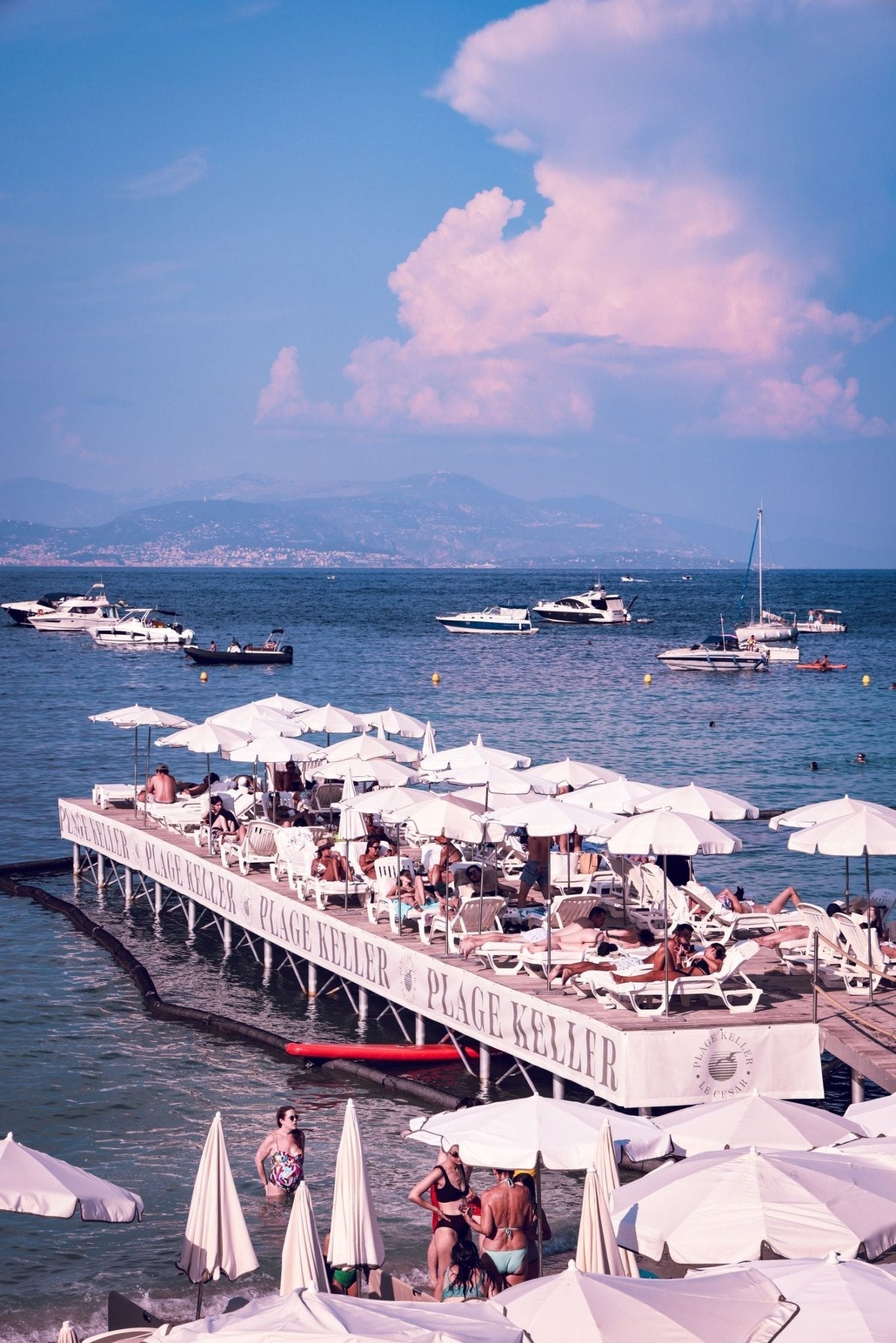 Keller Print of Plage Keller with beachgoers enjoying the sun and beautiful scenery in the South of France.