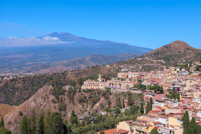 Aerial view of a Sicilian town with Mount Etna in the background, representing Sicily fine art photography.