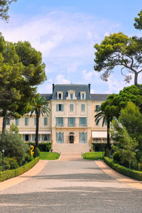 Eden Roc Print of the luxurious Hotel du Cap Eden Roc in Antibes surrounded by lush greenery and palm trees.